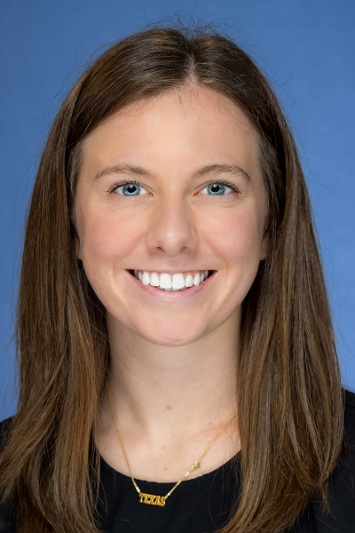 Sarah Mayberry headshot; woman with long brown hair and blue eyes wearing black shirt