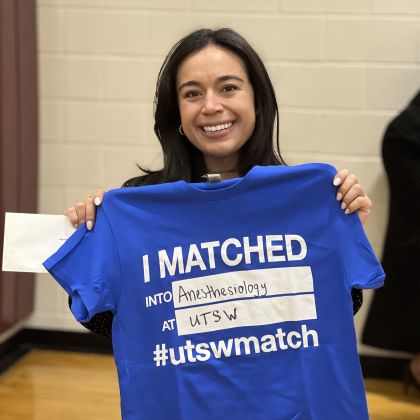 woman holding shirt which reads I matched at UTSW in anesthesiology