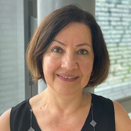 Irina Gasanova, M.D., white woman, short brown hair, wearing black top, smiling