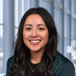 headshot of Evelina Quintanilla wearing a green jacket