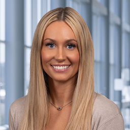 Isabelle Carroll wearing a tan shirt, standing in the Clements University Hospital lobby