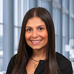 a woman with dark long hair wearing a black shirt