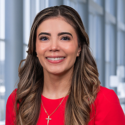 Lyssa Tijerina wearing a red shirt, standing in the Clements University Hospital lobby