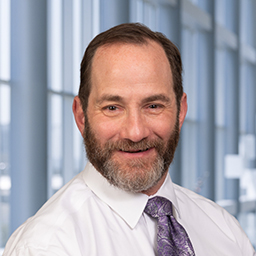a man with a beard wearing a white shirt