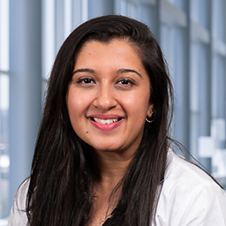 Dr. Shifa Kanjwal wearing a white lab coat standing in the Clements University Hospital lobby