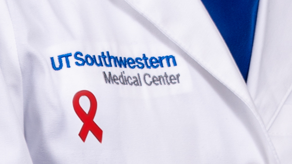 UT Southwestern logo on a jacket with a red AIDS ribbon button