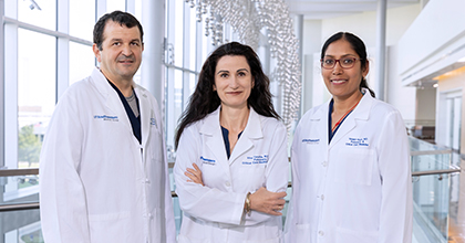 three doctors standing in the CUH lobby