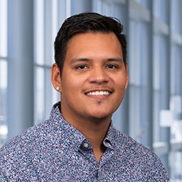 Dr. Jose Alberto Maldonado wearing a patterned shirt standing in the Clements University Hospital lobby