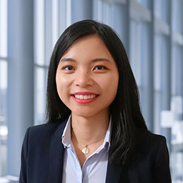 Dr. Yaling Tang wearing a blue shirt standing in the Clements University Hospital lobby