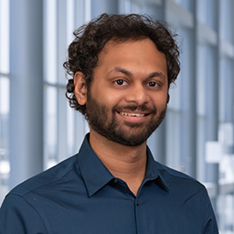 Dr. Muhammad Shariq Usman wearing a dark blue shirt standing in the Clements University Hospital lobby