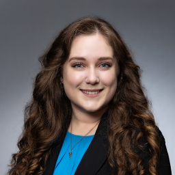 avery Hagar wering a teal colored shirt and a black jacket