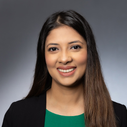 Maishara muquith wearing a green shirt with a black jacket