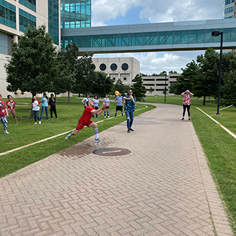 Team member attempts to catch water balloon while five people look on