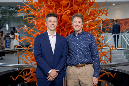 2024 Graduation two men in front of sculpture