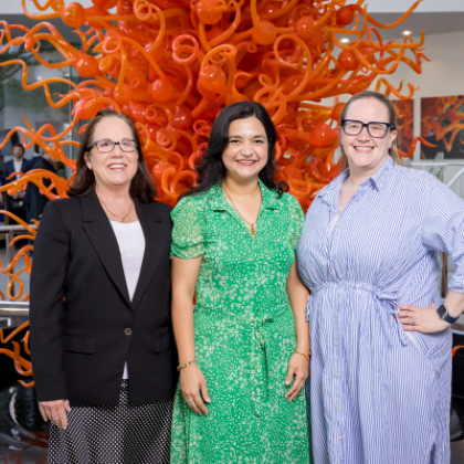 2024 CL Graduation three women in front of orange colored sculpture