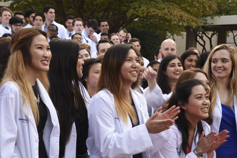 White Coat Ceremony Students in white coats stand in a group outside