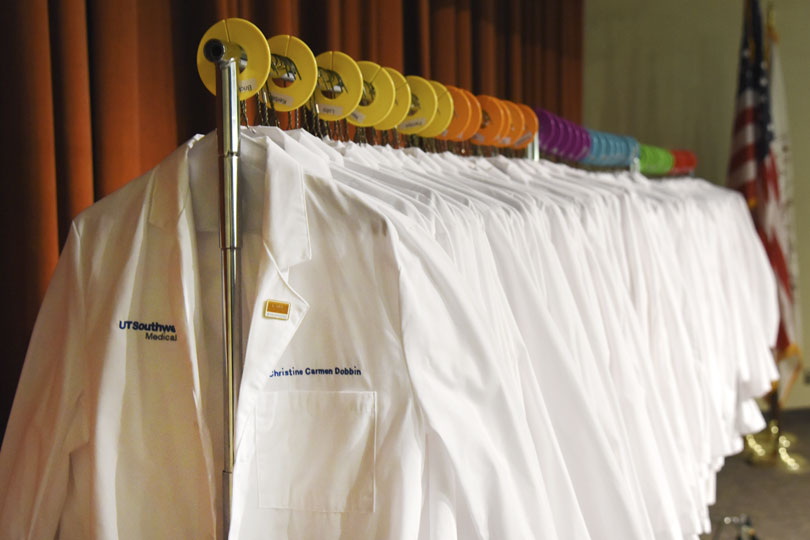 White coats hang on a rack at the White Coat Ceremony. White coats hang on a rack at the White Coat Ceremony.