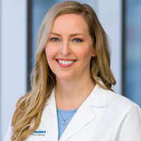 woman with long, wavy blonde hair wearing a pale blue shirt and white coat with UT Southwestern Medical Center logo