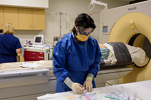 CT Scan Suite Two people in scrubs with patient in scanner