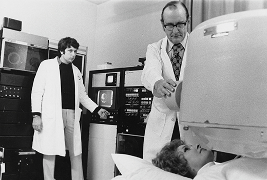 Parkey and Bonte Conducting a Nuclear Scan Doctors perform scan on a woman lying beneath large equipment