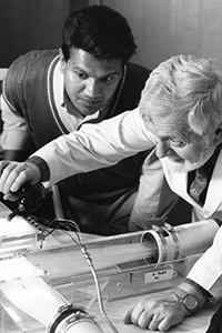 Peter Antich and a Student Dr. Antich adjusts equipment as student watches closely