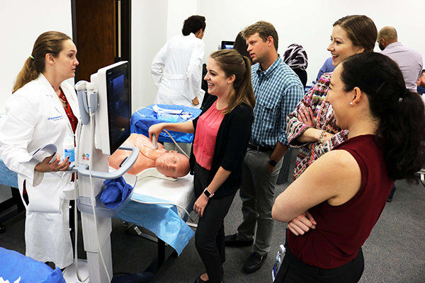 Assistant Professor Sarah Oltmann, M.D., guides first-year residents during a central line placement training class. Assistant Professor Sarah Oltmann, M.D., guides first-year residents during a central line placement training class.