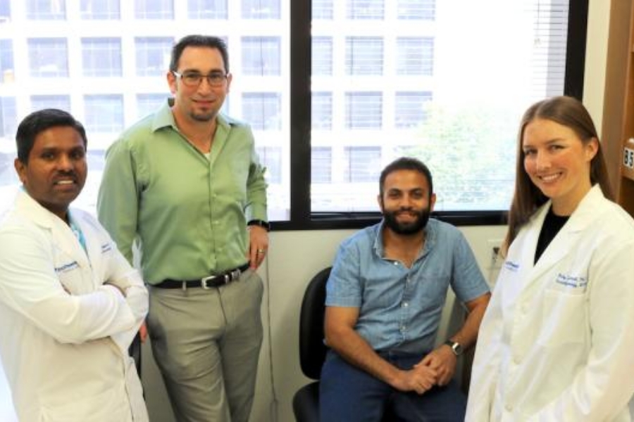 4 smiling lab associates including PI Todd Aguilera (second from left) of the Aguilera Lab at UTSW