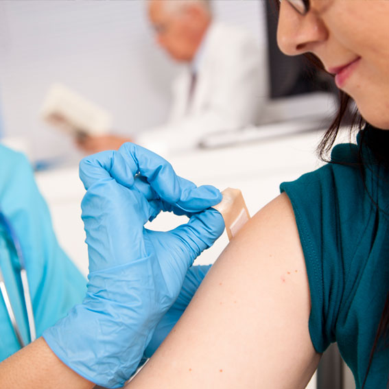 Student having a bandaid put on her upper arm