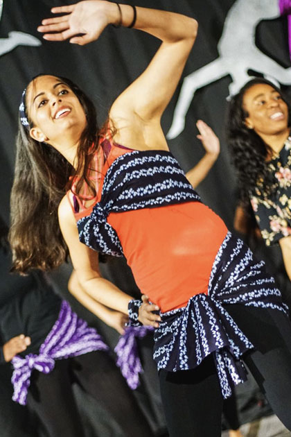 Dancing in African attire. Two students perform an Indian dance.
