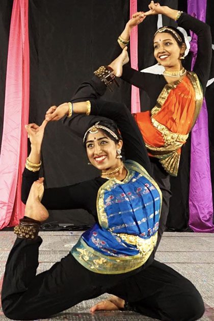 Two students perform an Indian dance.