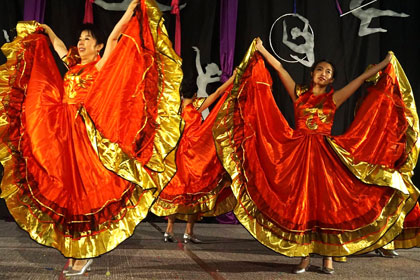 Students perform a folk dance. Students perform a folk dance.