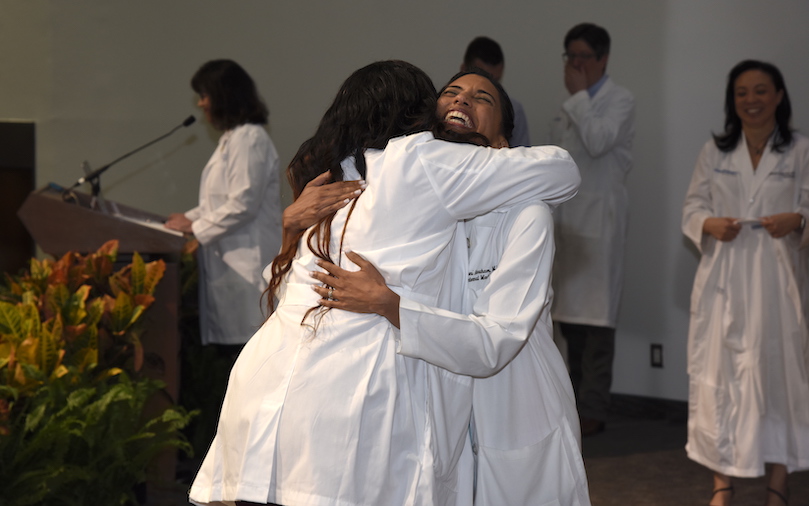 White Coat Ceremony A female student hugs a female advisor when she gets her white coat