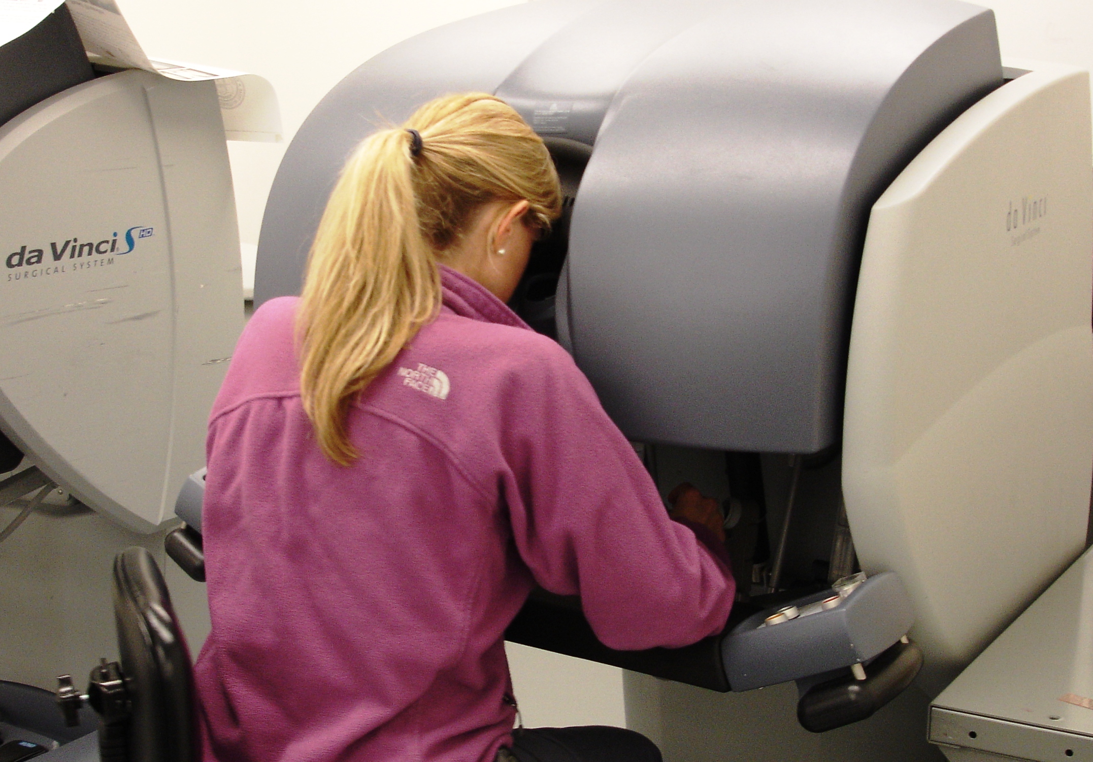 Robotic surgery Woman looking into control console