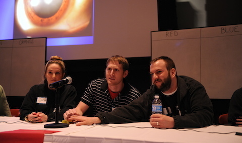 A three-student team rings in during Knowledge Bowl, part of Convergence Day. Knowledge Bowl