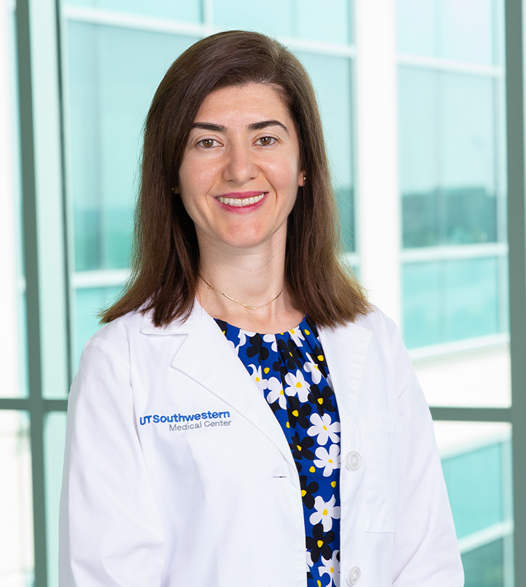 Maria Chahrour, Ph.D. A woman with shoulder-length brown hair and wearing a white coat