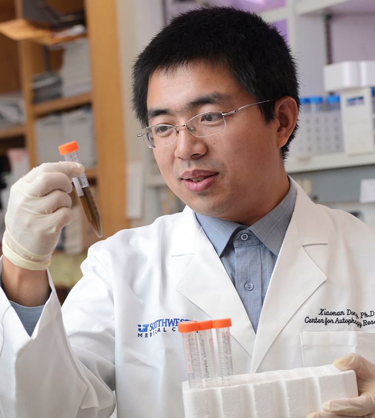 Xiaonan Dong, Ph.D. A man with black hair, glasses, wearing lab coat