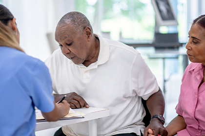 A Black man talking with a doctor