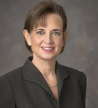 Beth Levine, M.D. A woman with brown hair and black blazer