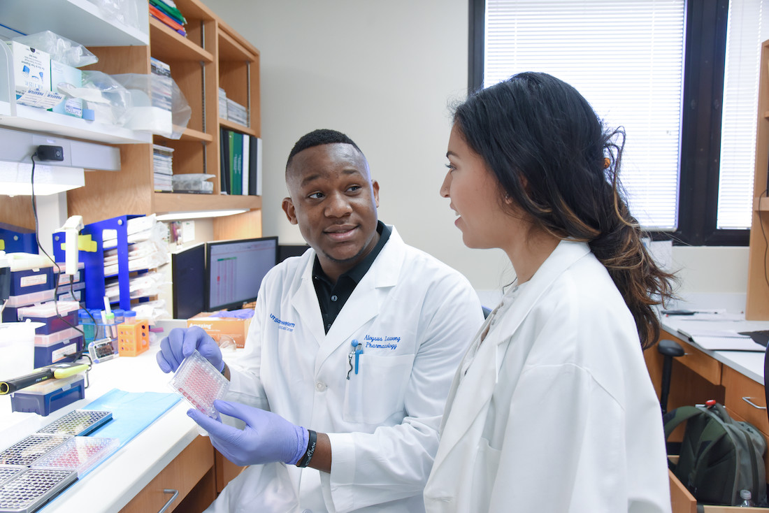 A man and woman in white lab coats photo A man and woman in white lab coats photo