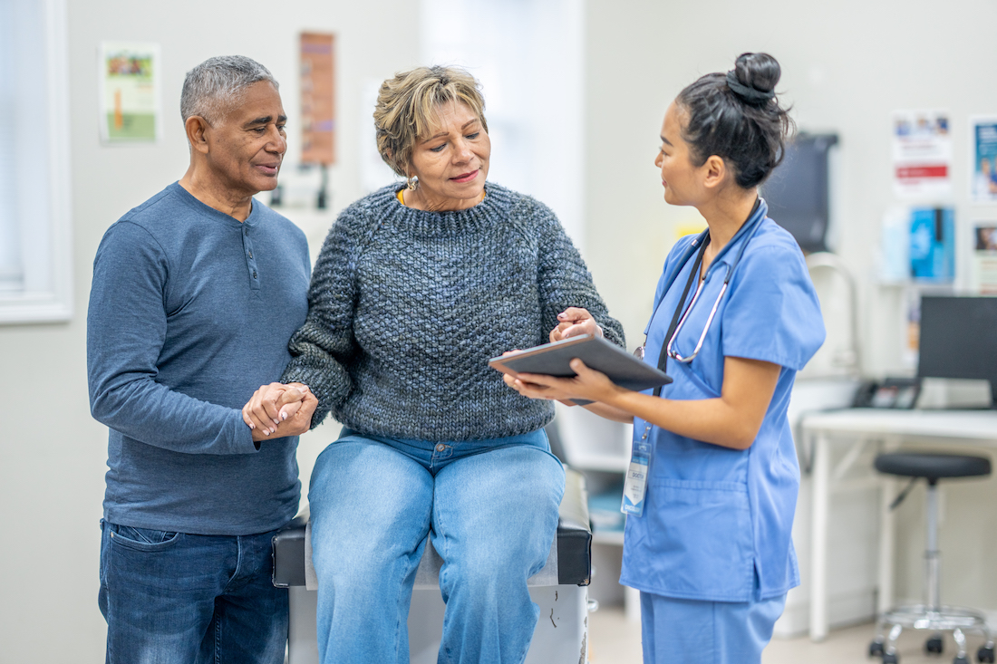 Female patient in exam room speaking with female physician