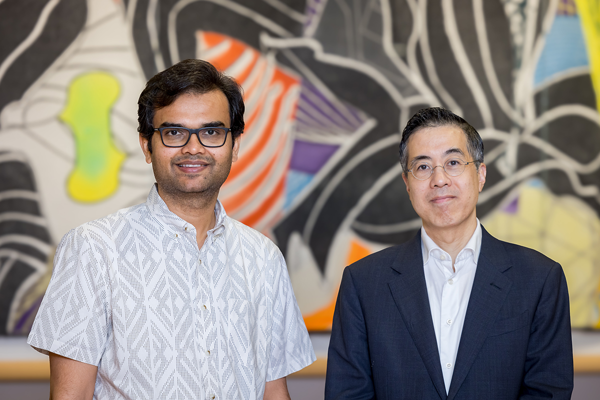 Dr. Ambarish Pandey and Dr. Thomas Wang standing in front of artwork