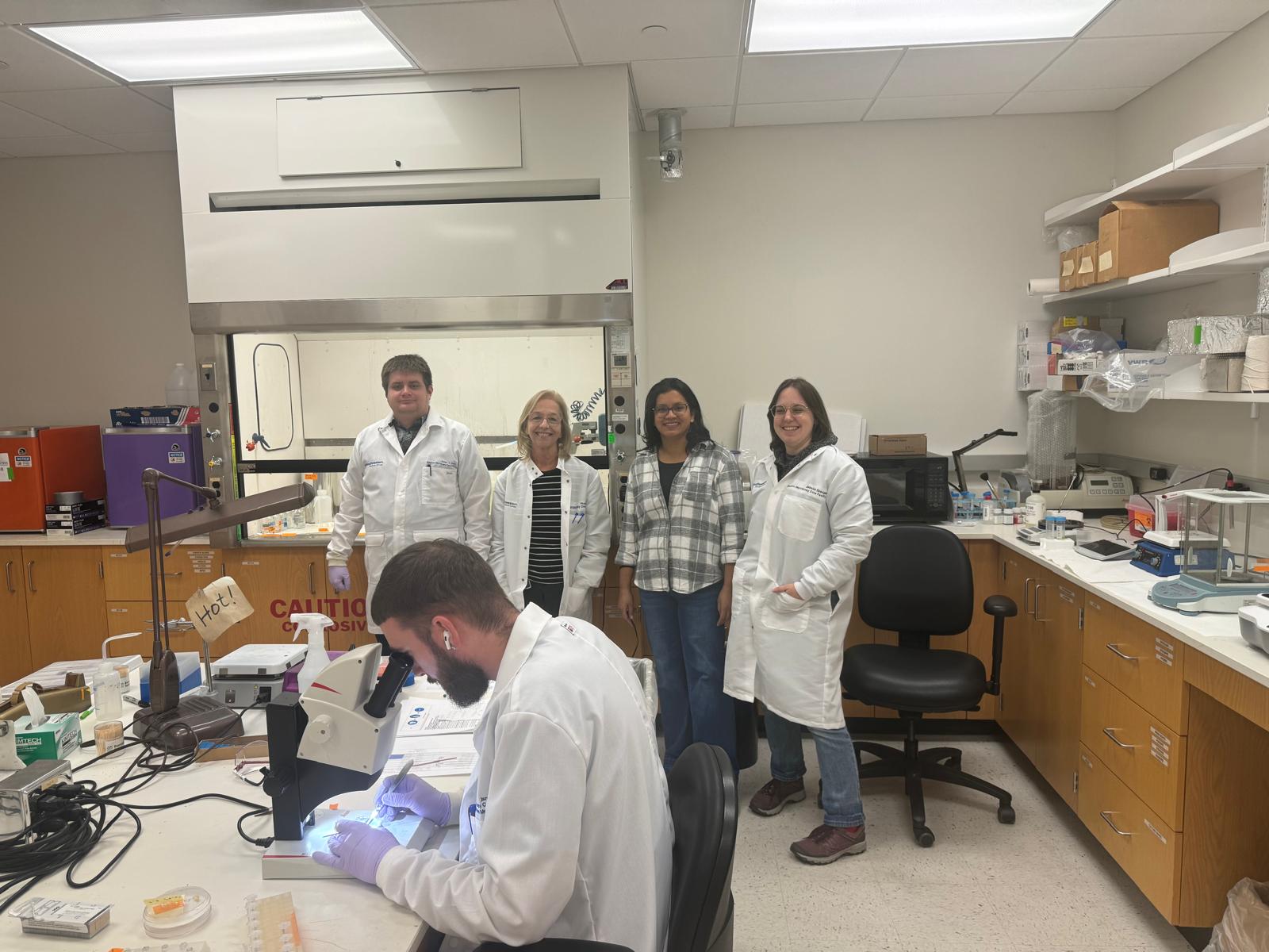 Top L to R: Ethan Ozment (EM Tech), Phoebe Doss (MGR Lab), Pratima Pandey (Resch Sr Scientist), Rose Spangler (EM Tech) Bottom: Jaryd Gipson (EM Tech) photo of four staff members