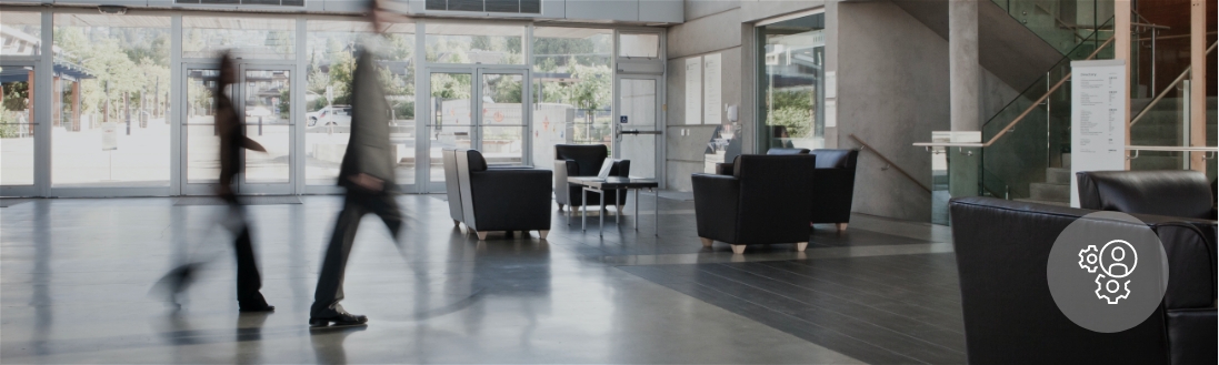 Two people are a blur as they walk through a lobby